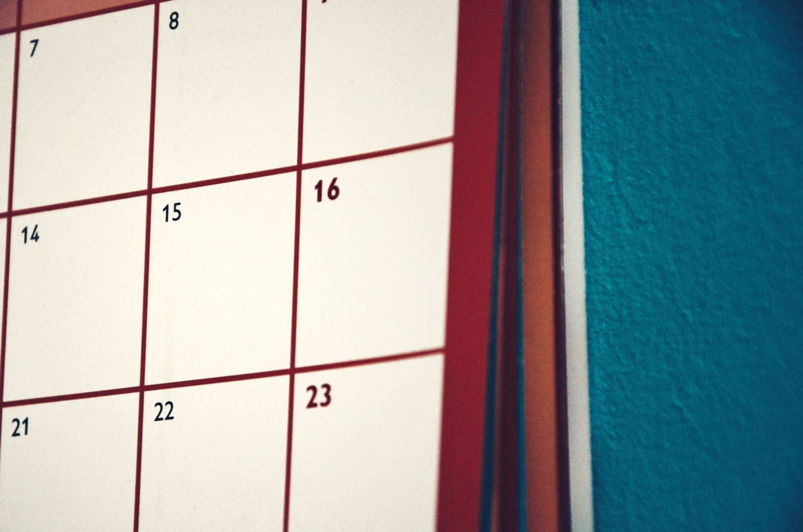 A close-up of a wall calendar grid with unmarked dates