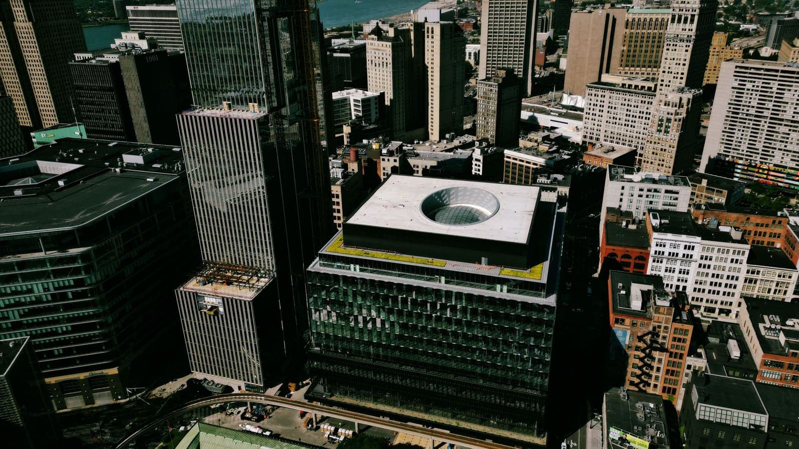 An aerial view of downtown Detroit with the Detroit River behind the towers